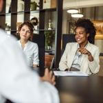 Business managers collaborating during a meeting with a prospective partner. 