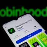 Robinhood, a financial investing app, and its logo displayed on a smartphone.