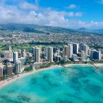An aerial photo of Honolulu, Hawaii's coast and skyline.