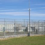 A fence, barbed wire and a guard are visible at the Allan B. Polunsky Unit, the prison that houses the 169 men on Texas' death row in Livingston, Texas.