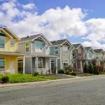 A row of colorful family homes in a residential neighborhood.
