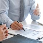 An insurance agent explaining a policy to a customer.