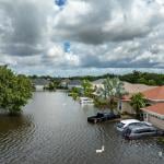 Homes, cars, and roads submerged in floods from a recent typhoon that affected the area. 