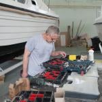 A person looking for an item on a tool box set for a boat repair. 