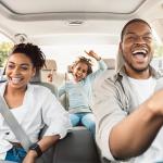 A happy family enjoying a summer road trip.