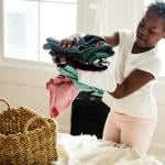 A young girl folding laundry