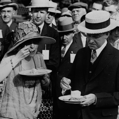 President and Mrs. Coolidge eat ice cream at a garden party for veterans at the White House.