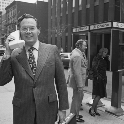 John F. Mitchell demonstrates the Motorola DynaTAC Portable Radio Telephone.