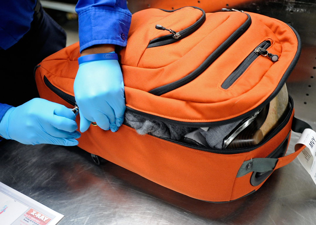 Transportation Security Administration officer inspects a bag.