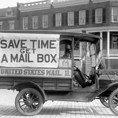 Mail wagon with “Save Time Get a Mail Box” sign