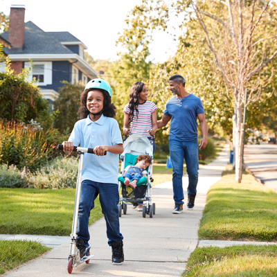 Family walking on suburban street.