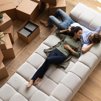 Overhead view of a couple relaxing on new sofa.