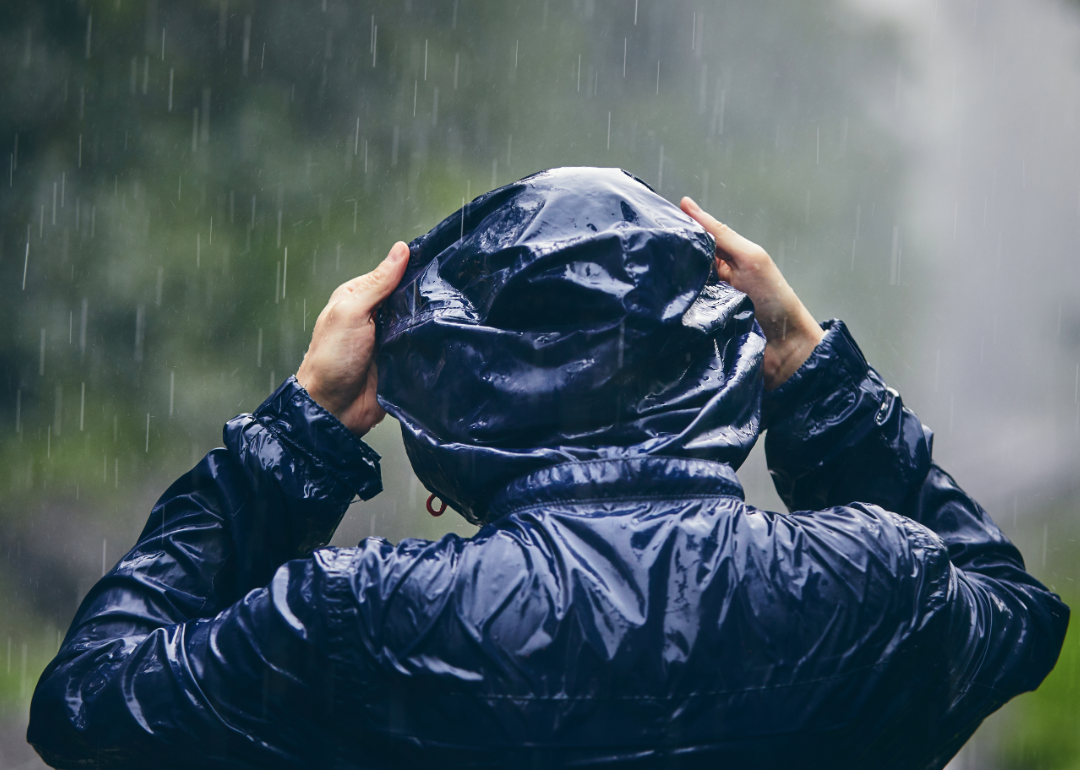 Person with rain jacket in storm.