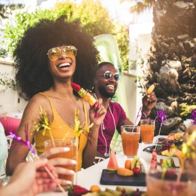 A group of friends enjoying food and drinks in a backyard.