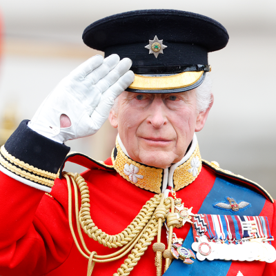 King Charles III takes the salute outside Buckingham Palace after Trooping the Colour.