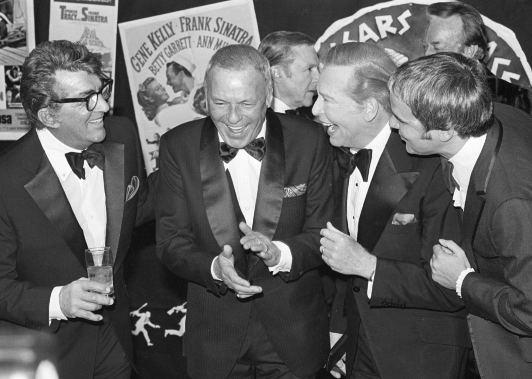 Frank Sinatra laughs with friends at a party.