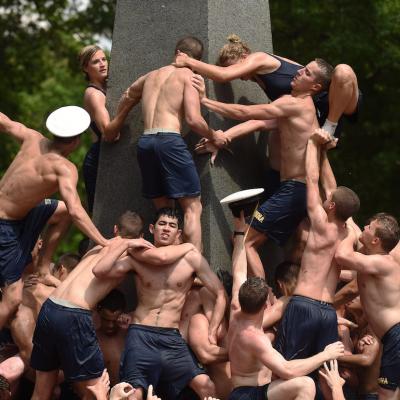 Plebes take part in the annual Herndon Monument Climb at the United States Naval Academy on Monday May 18, 2015 in Annapolis, MD