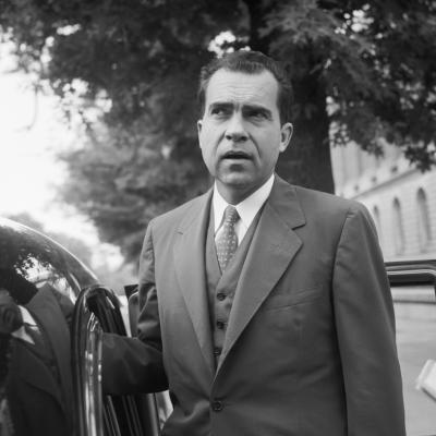 Richard Nixon speaks with members of the media before leaving his Capitol Hill office.