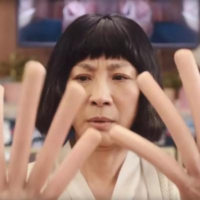 Michelle Yeoh looks bewildered at long fingers in "Everything Everywhere All at Once"