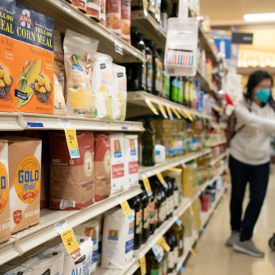 Woman in a grocery store shopping for flour in San Mateo, California