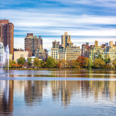 View of apartment buildings across reservoir in New York's Central Park