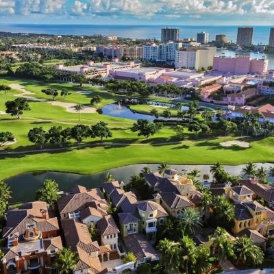 View of a large houses, golf courses, and high rises in Boca Raton, Florida.