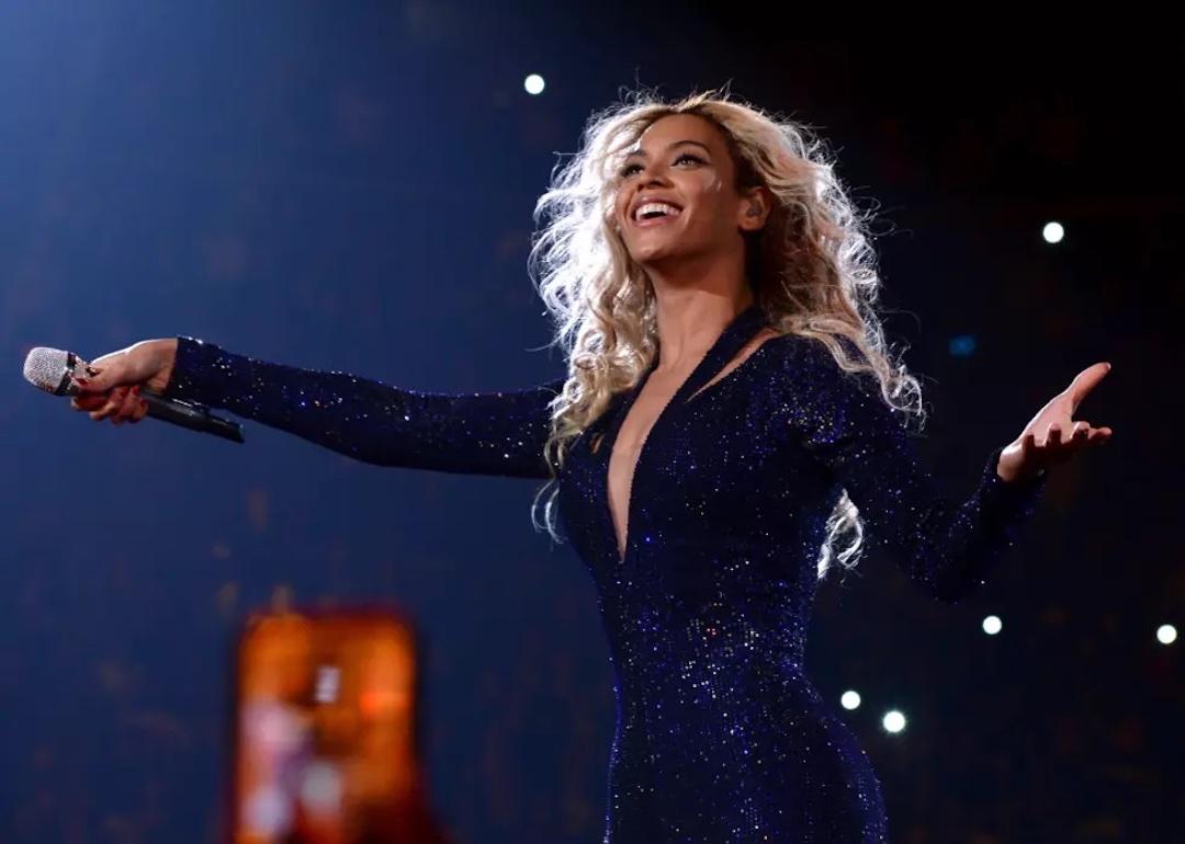 Beyonce opens her hands to the crowd as she performs on stage