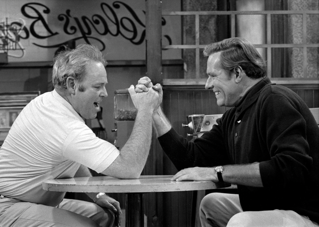 Carroll O'Connor as Archie Bunker arm wrestles Philip Carey as Steve in an episode of "All in the Family"