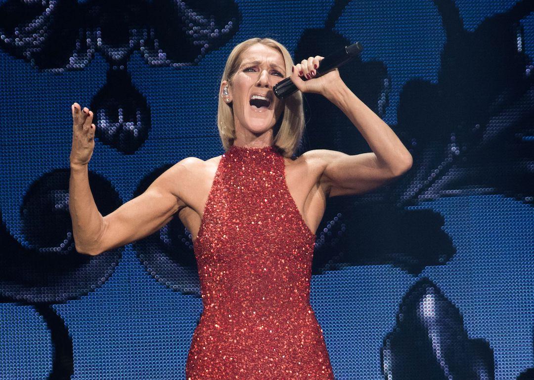 Celine Dion performs in a red dress.