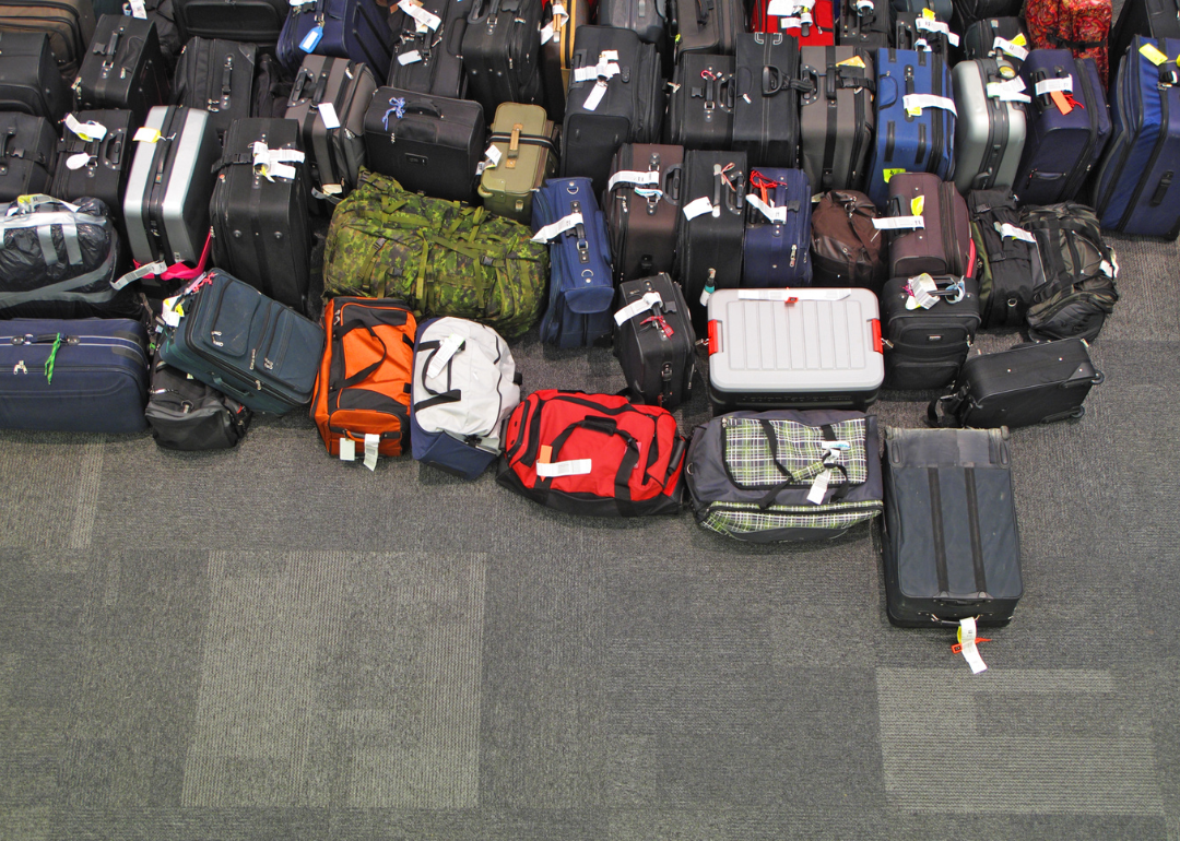 Lost luggage lined up on the floor in the airport.