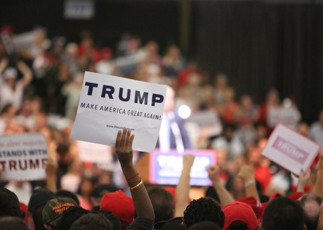 Supporters and fans of Donald Trump wave signs at a campaign event in 2016.