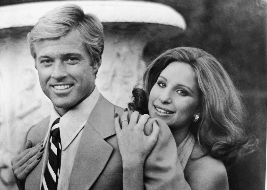 Barbra Streisand hugs Robert Redford from behind in this publicity still from the movie 'The Way We Were.'