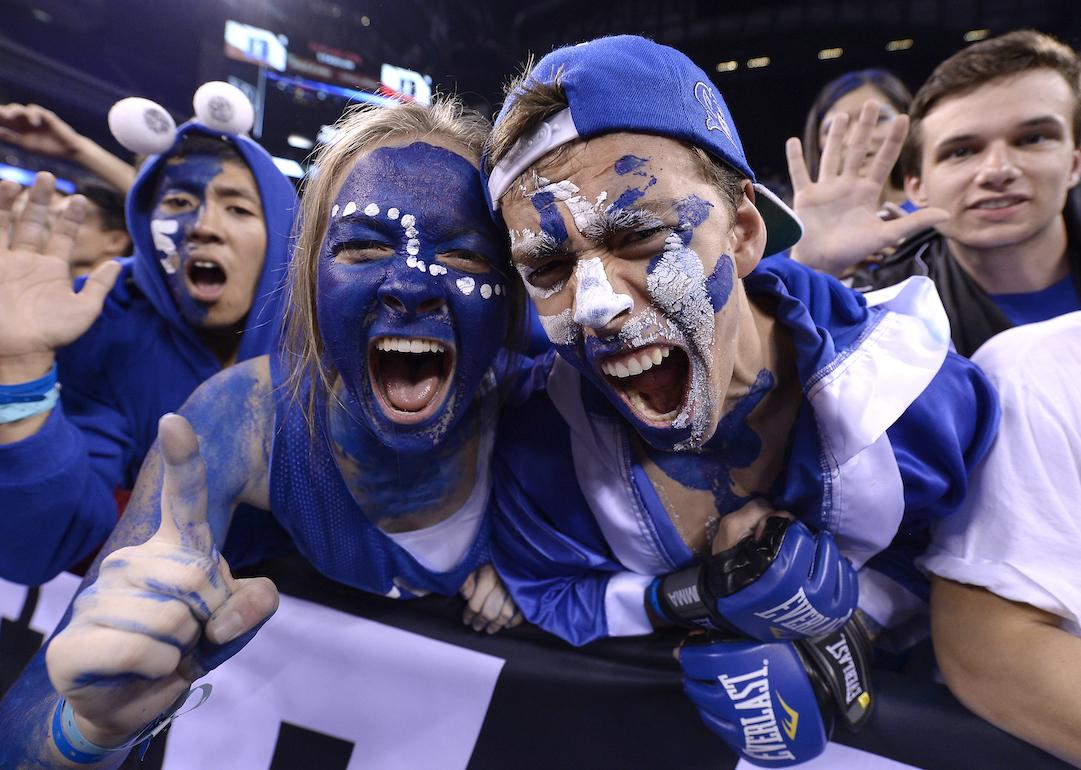 Duke Blue Devils fans with their faces painted celebrate during the NCAA Championship Basketball game in 2015.