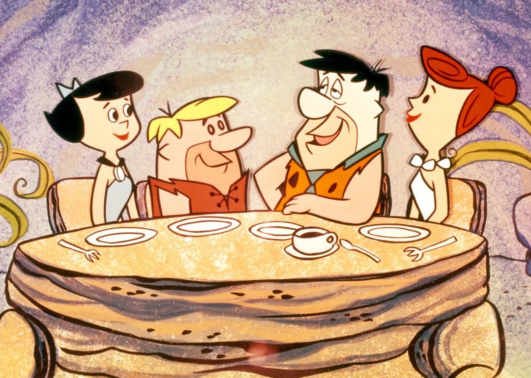 Betty Rubble, Barney Rubble, Fred Flintstone, and Wilma Flintstone of the hit 1960s animated comedy series 'The Flintstones.'