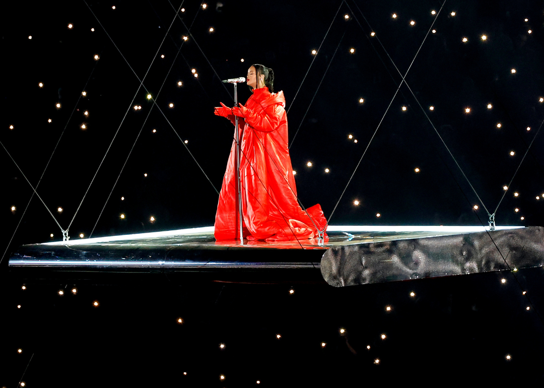 Rihanna wearing all-red ensemble while performing Super Bowl LVII halftime show.