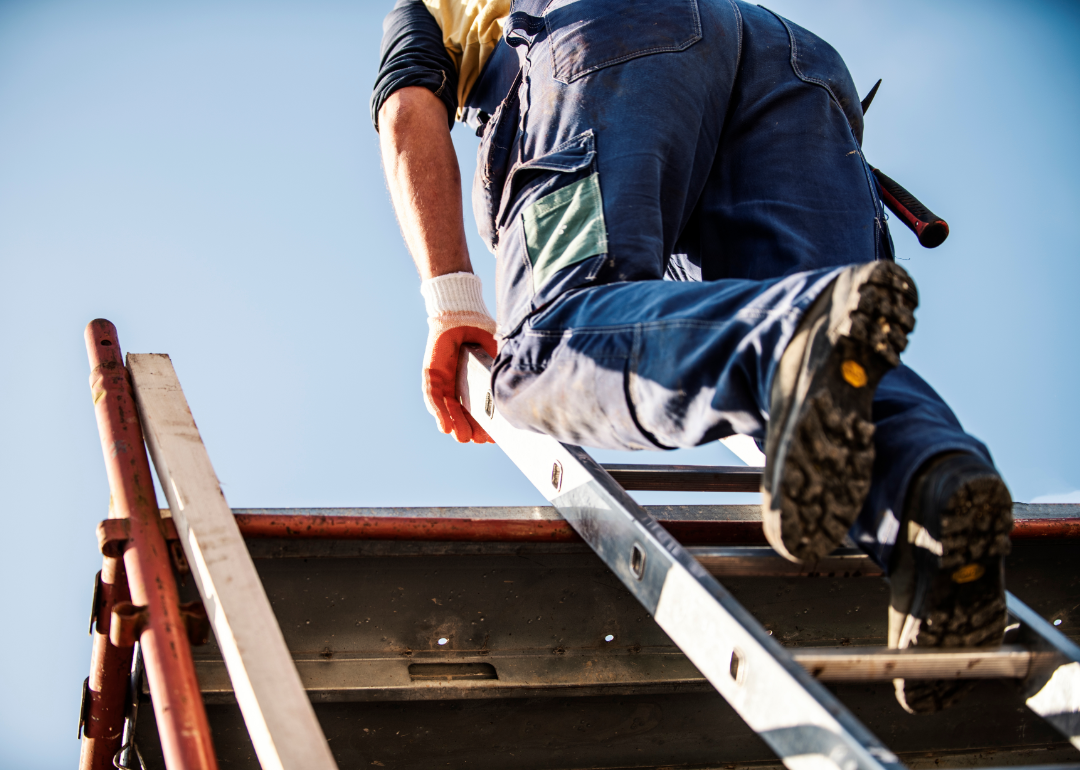 Construction roofer on ladder.