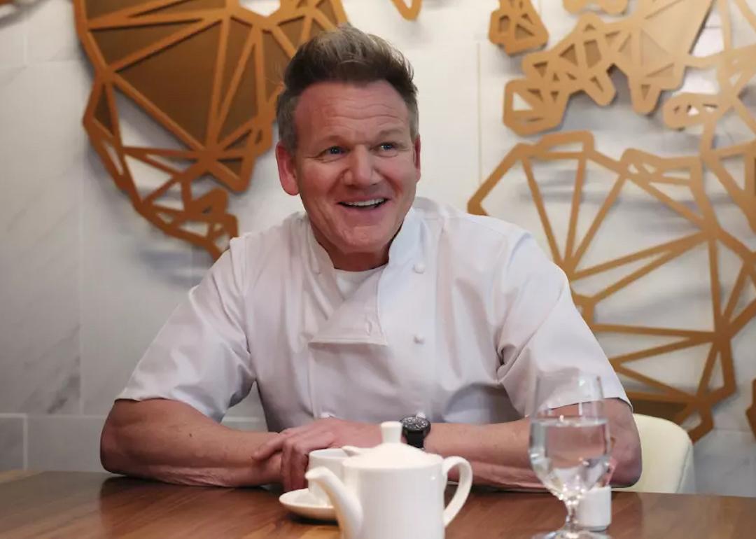Gordon Ramsay smiles during an interview while wearing his chef's coat.