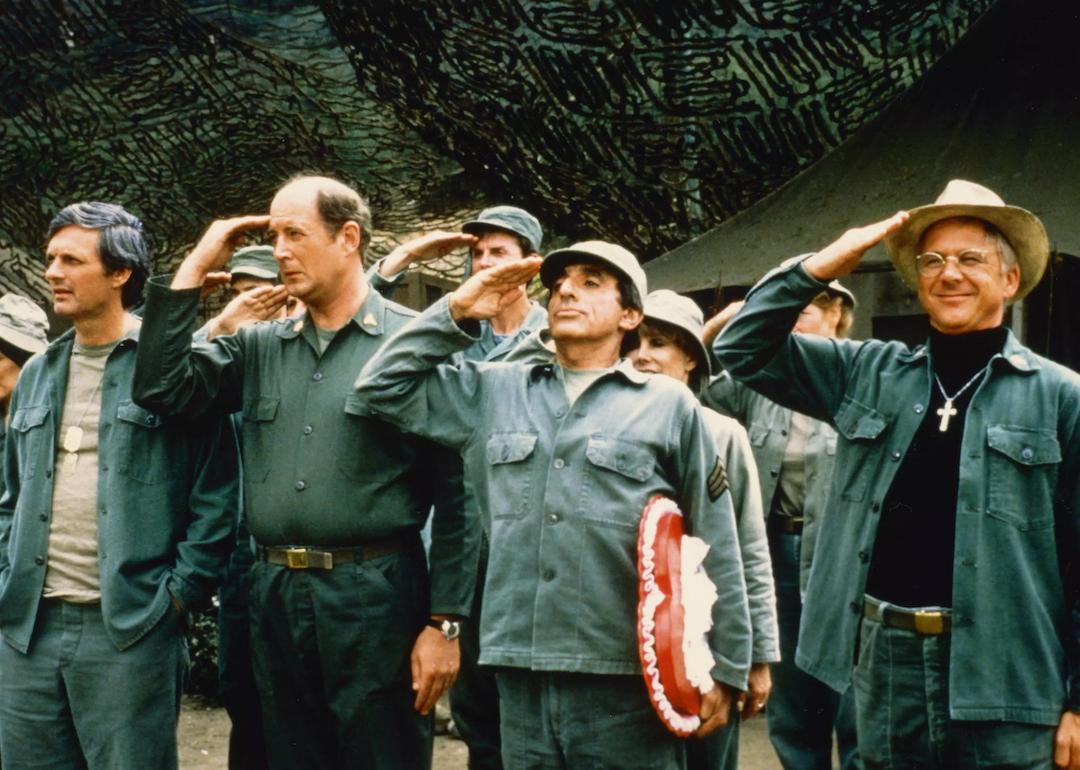 Actors Alan Alda, David Ogden Stiers, Jamie Farr, and William Christopher, saluting in a publicity still issued for the television series 'M*A*S*H', in 1975.