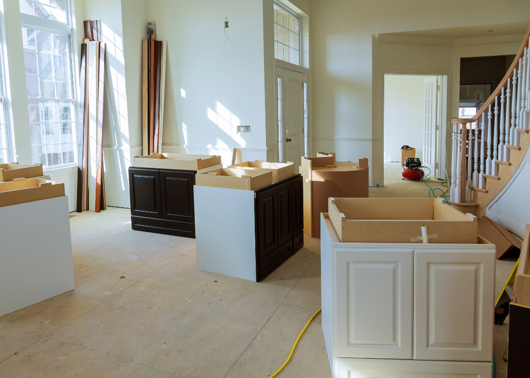 A kitchen in a spacious apartment is in the midst of being remodeled.