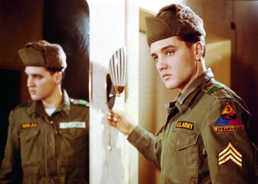 Actor and singer Elvis Presley poses for a portrait next to a mirror during his tour of duty in Germany in February of 1959.
