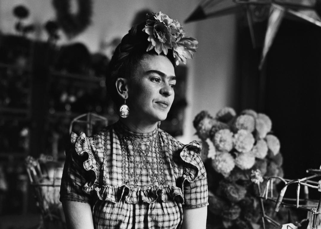 Artist Frida Kahlo sits on a table in 1944.