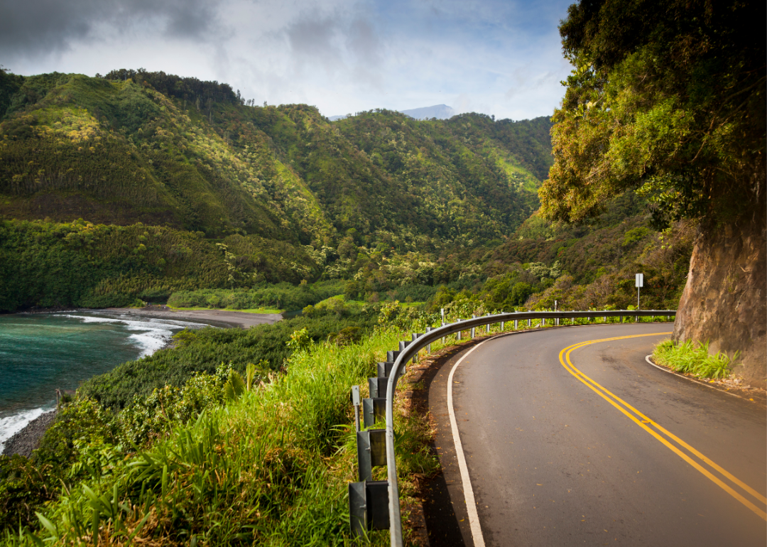 The scenic Hana Highway surrounded by greenery on the east coast of Maui in Hawaii.