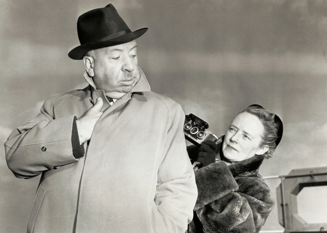 Alfred Hitchcock poses for a "sinister" type snapshot for his wife Alma Reville