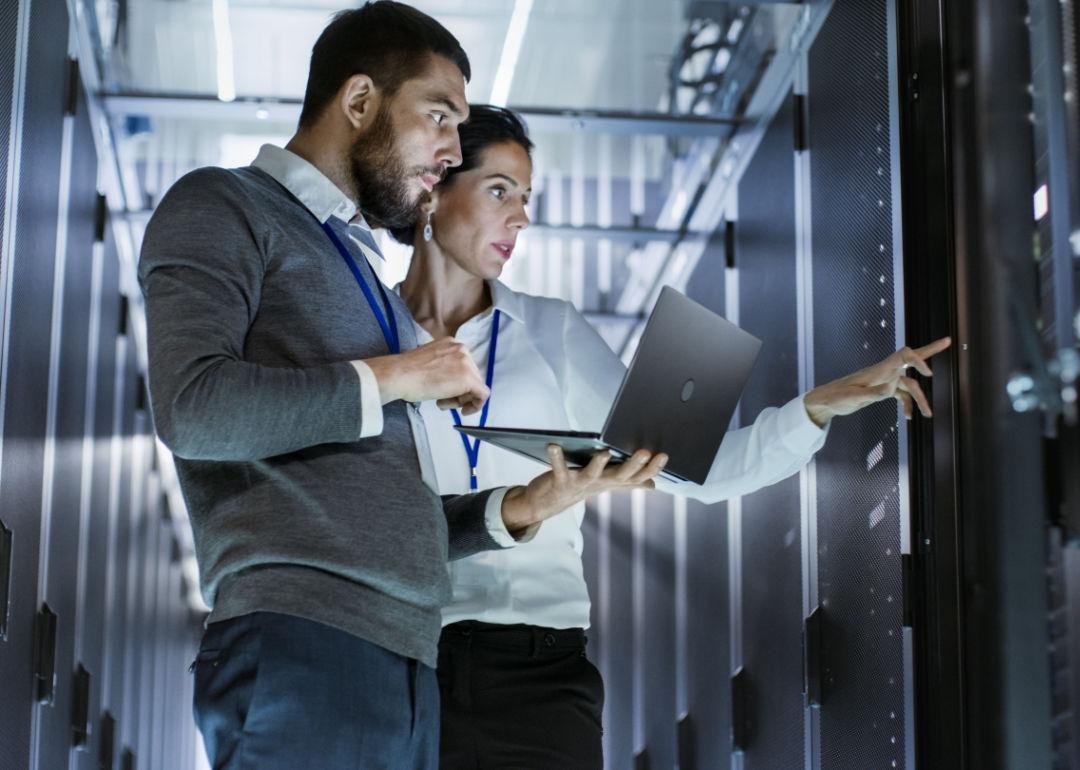 Two cybersecurity specialists walking through a data center.