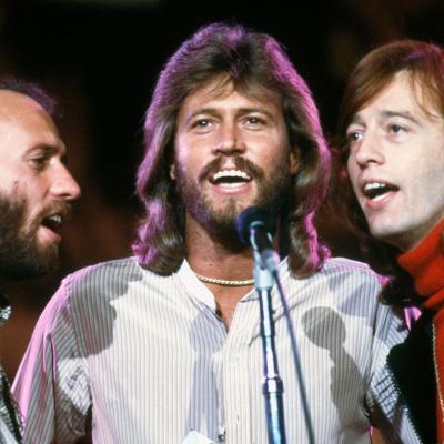 Musicians Maurice, Barry, and Robin Gibb, of the group the Bee Gees, sing at a benefit concert for UNICEF at the UN HQ, in New York, New York, on Jan. 9, 1979.