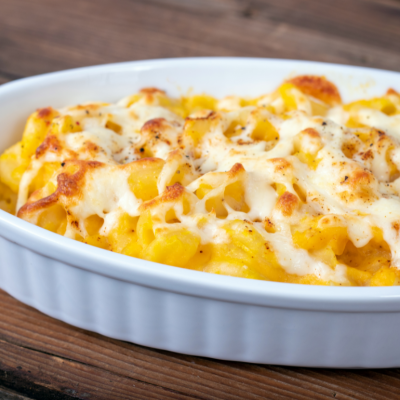 Butternut squash mac and cheese in a white dish.