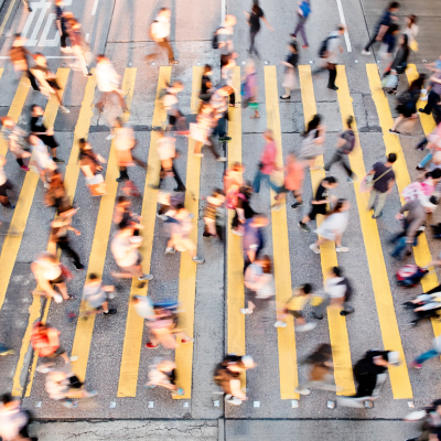 Pedestrians crossing a busy intersection in a city