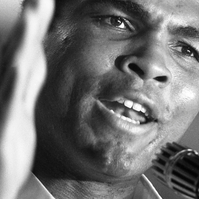 Champion heavyweight boxer Muhammad Ali addresses fans and supporters during press conference during training session in Manila, Philippines, prior to his winning bout against Joe Frazier in September 1975.