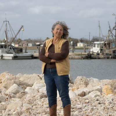 Diane Wilson stands in front of a bay in Texas
