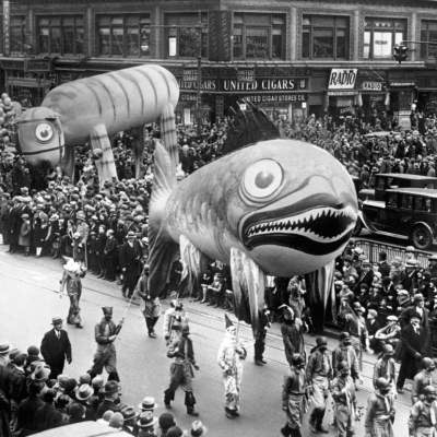 Crowds on the streets of New York City watch the annual Thanksgiving Parade passing by, 1928.